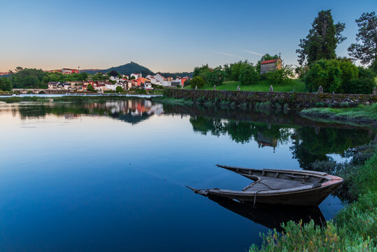 Landscape in the Rias Baixas, semi-sunken boat next to Illa Medal and the municipality of Arcade and Pontesampaio in the background, Pontevedra, Galicia.