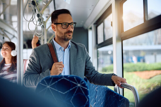 Pensive businessman commuting by public transportation.