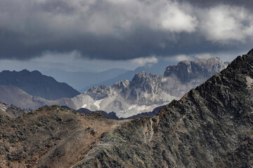 Layers of Austrian Alpine rocks and mountains stretch into the distance, showcasing the geological complexity of the region.