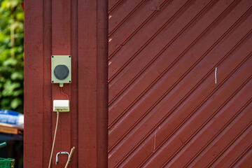 Red wooden barn with external power outlets.
