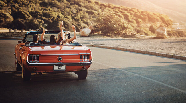 Back view, freedom and friends in car for road trip by sunset for countryside vacation or holiday. Adventure, travel and people in convertible for driving to destination on weekend trip in Ireland.