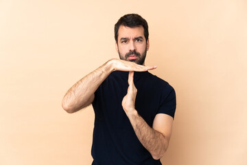 Caucasian handsome man over isolated background making time out gesture