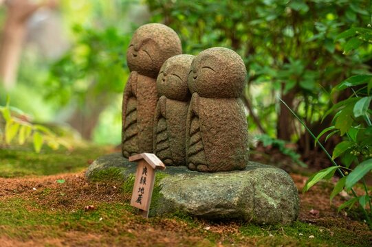 Three Smiling Jizo Statues in a Garden