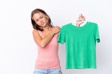 Young Russian girl holding hanger isolated on white background suffering from pain in shoulder for having made an effort