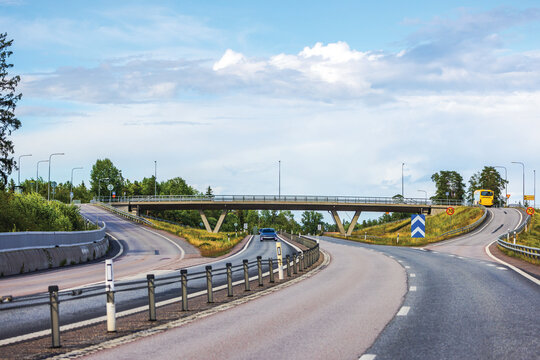 Picturesque view of highway interchange with bridge and moving vehicles, showcasing dynamic flow of modern transportation. Sweden.