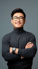 Obraz premium Smiling man in a black turtleneck, glasses, and watch poses with arms crossed