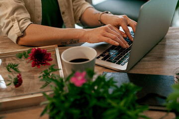 Florist, typing and hands on laptop in flower shop, sustainable business and email with online...