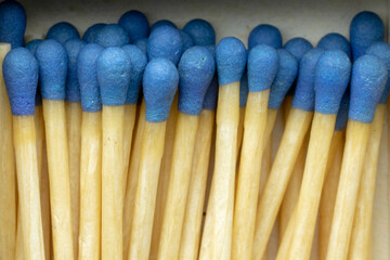 Set of wooden matches with the head or blue flammable material.