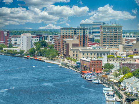 Aerial view of Wilmington North Carolina historic district along the Cape Fear river with cloudy sky
