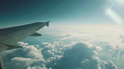 Obraz premium Plane window shot showing a wing, clouds, and the Earth's curve, capturing a high-altitude space-like perspective