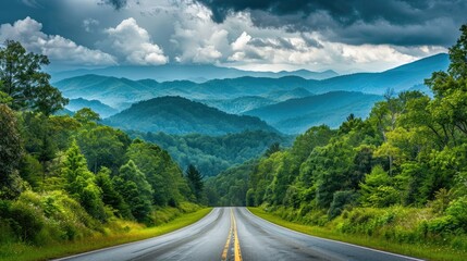 Fototapeta premium Road leading to the Great Smoky Mountains National Park, Tennessee, with a picturesque view of lush forest and rugged mountain terrain