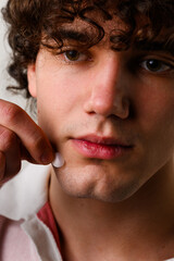 Fototapeta premium Young man uses acne stickers as bandage not to touch or squeeze pimple. Using acne pimple patch to clean the face from zits.