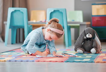 Notebook, teddy bear and young child writing in psychology office for social development. Growth, plush toy and girl kid patient drawing on floor at healthcare clinic for cognitive behavioral therapy