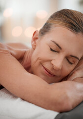 Spa treatment, sleep or mature woman on bed for massage, salon therapy or luxury. Rest, eyes closed or female person in health resort for destress, peace or wellness in hotel for pamper or me time