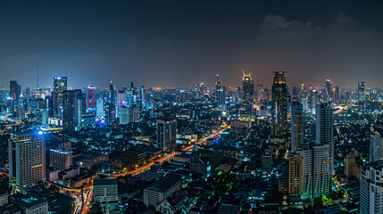 Fototapeta premium Panoramic view of Bangkok's bustling business district at night, illustrating the cityscape illuminated with lights and skyscrapers, portraying urban vibrancy and economic activity.