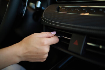 Expert is operating the control panel of a luxury vehicle with advanced technology and sleek design