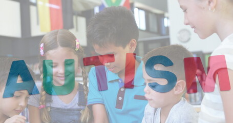 Image of colourful puzzle pieces and autism text over school children using tablets