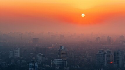 Fototapeta premium Smoky haze over a cityscape at sunset
