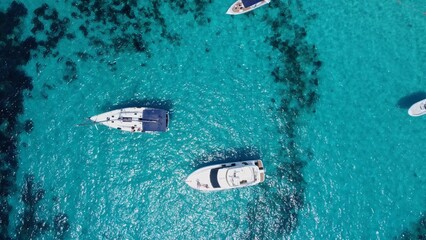 Boats floating in the crystal clear turquoise sea water. Blue lagoon, Comino, Maltese Islands. Aerial high angle view. High quality photo