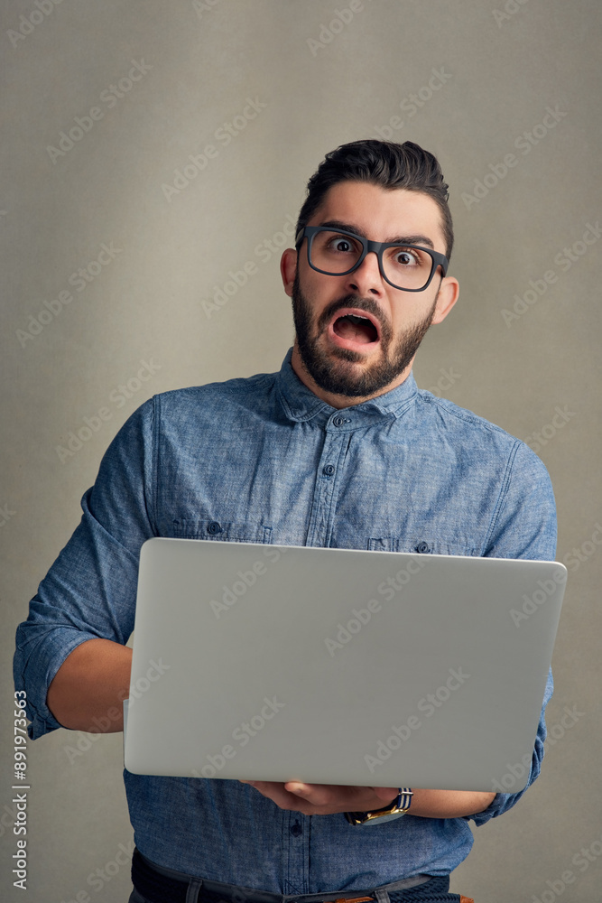 Poster shock, surprise and portrait of businessman on laptop in studio with bad news, notification or email