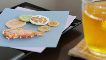 Summer Japanese inn services : Welcome sweets of rice crackers and a glass of cold green tea