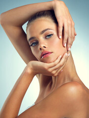 Naklejka premium Studio, calm and portrait of woman for skincare, healthy skin and wellness for transformation with pride. Girl, benefits and results with cosmetics for beauty treatment, serious and blue background