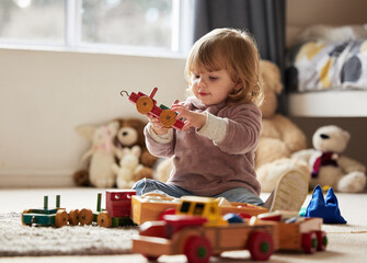 Baby, toys and play in home for development or learning, child in bedroom for motor skills. Young...