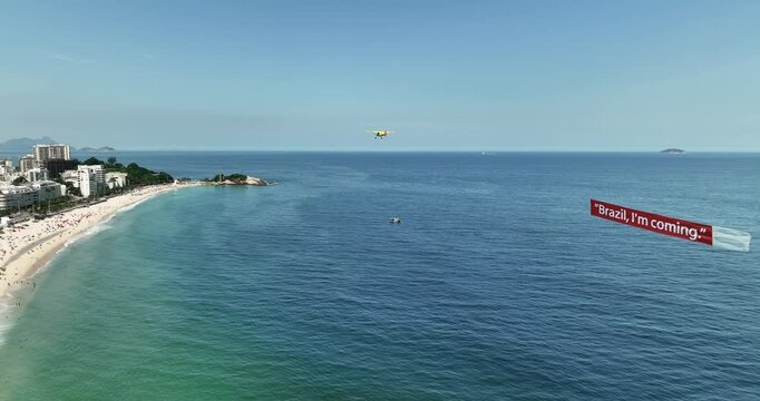 Small plane flying along Ipanema Beach with waving banner behind, Rio de Janeiro, Brazil