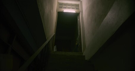Horror scene of a mysterious Scary Asian ghost woman creepy have hair covering the face walking down on staircase at abandoned house with dark scene movie at night, festival Halloween concept	
