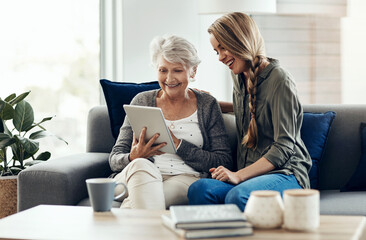 Tablet, sofa and woman relax with senior mother in home for help with online blog, internet or...