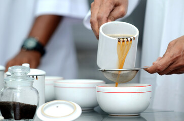 Detailed photo of tea drops tasted by a tea taster