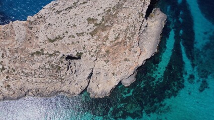 Natural windows in the rocks, Comino Island Malta, Close up revealing drone shot. High quality photo
