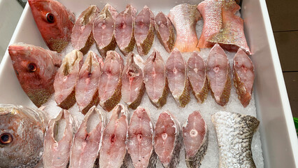 Slices of red snapper fish displayed in supermarket. Fresh seafood concept