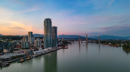 Fototapeta premium Aerial View of City Buildings by river at twilight. New Westmister, Vancouver, BC, Canada