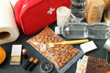 Necessities for emergency bag on dark table, closeup