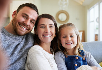 Parents, girl and happy on sofa for selfie in home for bonding, love and memories. People, family and kid on portrait with smile in living room on couch for fun, enjoy and relax for social media