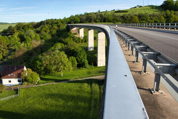 Bridge over a road on a sunny spring evening with blue skies in Rhineland Palatinate, Germany.