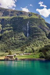Fototapeta premium Stunning view of Hardanger fjord in Norway with lush green mountains.