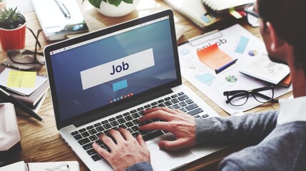 Fototapeta premium A man is typing on a laptop with the word job displayed on the screen, Finding a job, Hiring recruitment