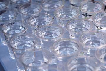 a collection of plastic cups filled with water, perfect for articles on the environment or global warming