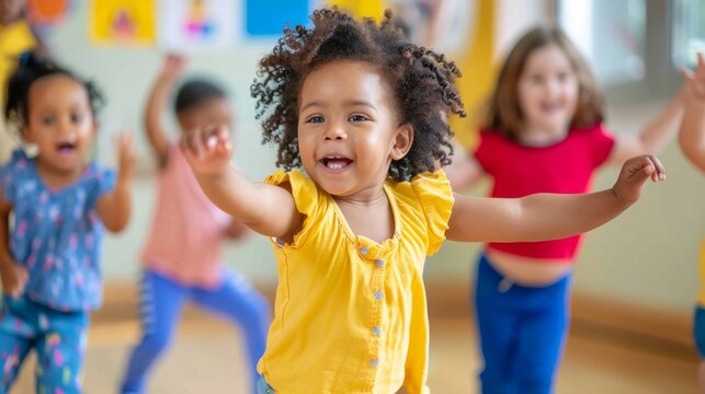 Children dancing happily together at nursery school