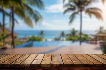 Clear wooden tabletop with a softly blurred background of a tropical resort pool, palm trees, and ocean view, perfect for product placement