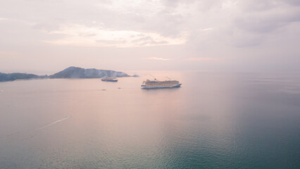 Obraz premium Aerial view, drone flying over Phuket city, Thailand. Drone over Patong Beach on Sunday in Phuket and tourists shopping at a street full of local merchants selling food, people resting by the sea.