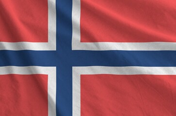 Fototapeta premium Norway flag depicted on folded wavy fabric of old cloth close up