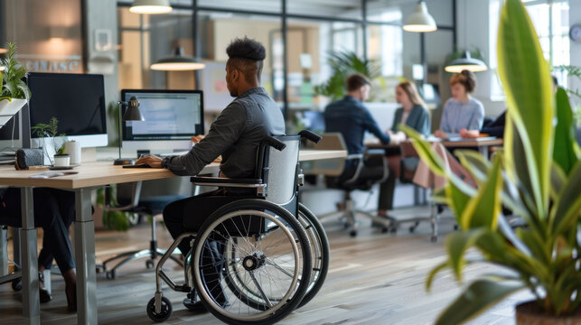 Inclusive Workplace - Wheelchair User Engaged in Office Collaboration with Colleagues