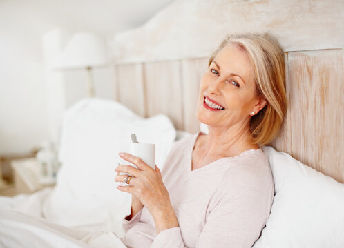 Senior woman, portrait and drinking tea in bedroom for relax or comfort on weekend with break, rest and reflection. Elderly, female person and remember in happiness, morning routine or memory in home