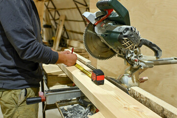 Wood wooden modular houses made of timber yellow board saw processing hands nail grind