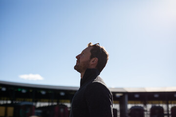 Fototapeta premium caucasian man blue sky looking up wishing hoping contemplating 