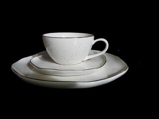 Coffee trio, cup, saucer and plate on white isolated background