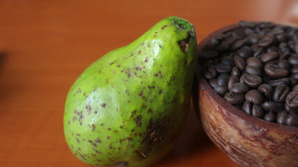avocado and coffee beans on a brown wooden table. Photo for advertising © amrisyam